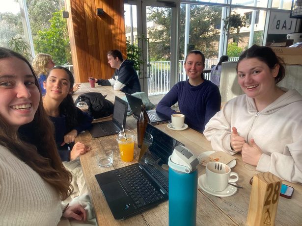 Students chatting over coffee at a campus cafe