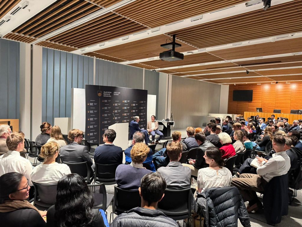 A large audience listening to a panel discussion at the ANU Law School