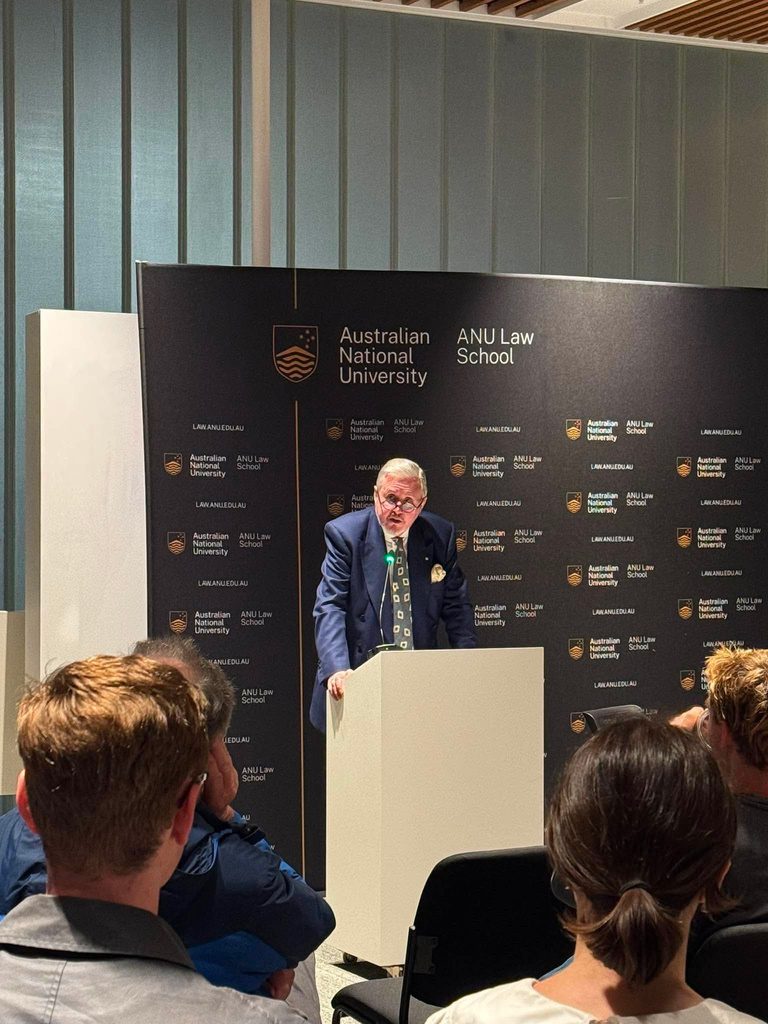 Justice Simon Steward speaking at a lectern at the ANU Law School
